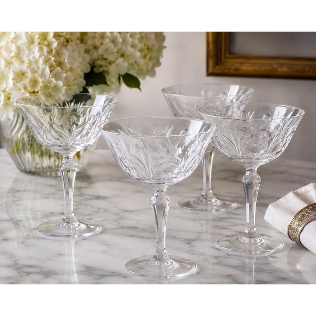 A beautiful set of four vintage Tiffin Franciscan Chardonnay etched crystal champagne coupes, showcasing the beloved...