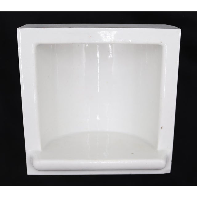 Flush mount square bathroom soap dish made of white porcelain over ceramic. Made by Fairfacts Co. Inc. Good condition with...