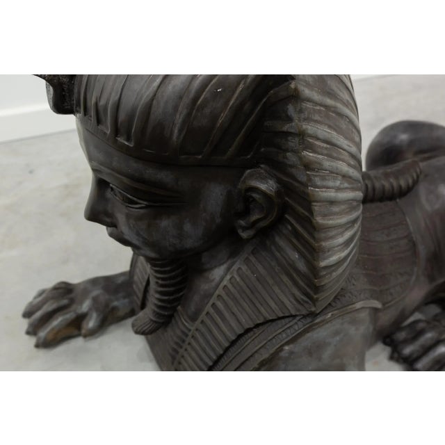 Couple of lying sphinters made in bronze with black skate. Sculptures in round bundle of fantastic animals, lions with...