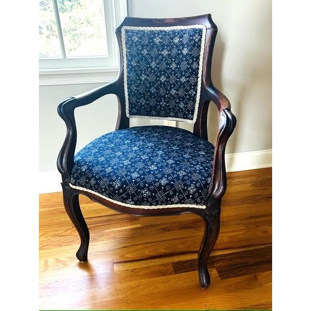 Beautiful English wood armchair upholstered in a vintage blue and white batik ikat fabric throw and highlighted with a...