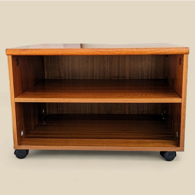 Bring timeless design into your home with this 1970s Mid-Century storage cabinet in rich teak. Design Highlights: - This...