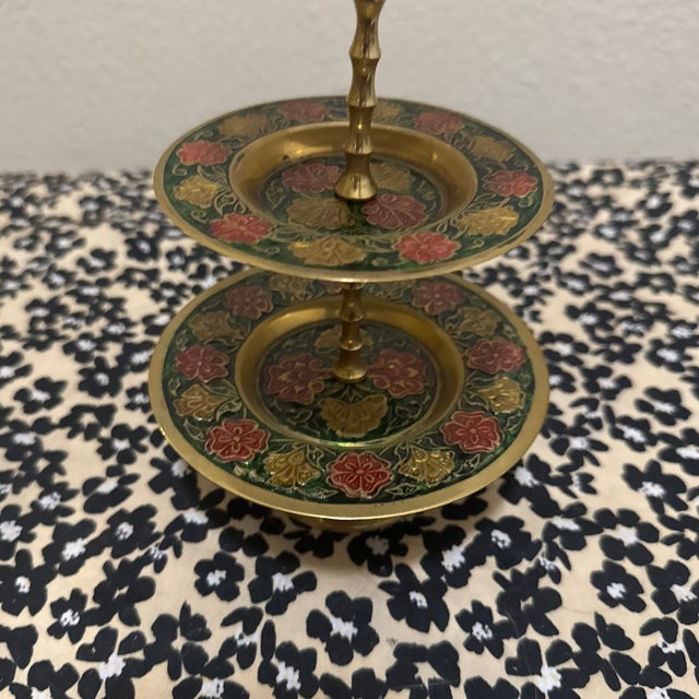 This vintage three-tiered stand is an Indian-made etched brass and enamel piece, typically dating from the 1970s. It...