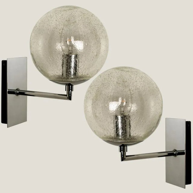 Wonderful high-end Doria wall lights. Manufactured in the 1960s in Germany, Europe by Doria Leuchten. with a clear and...