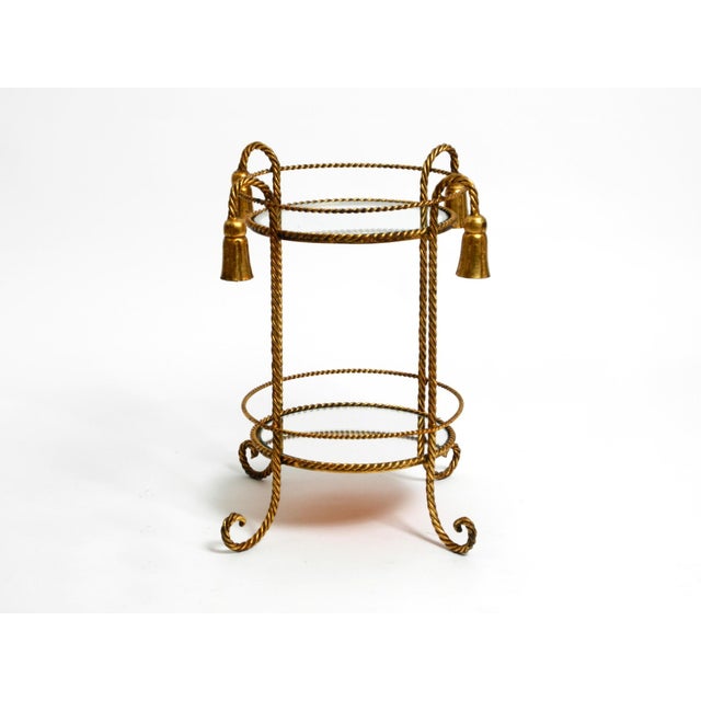 Very elegant, small Mid-Century Regency side table made of gold-plated iron. Manufacturer is Li Puma Firenze. Made in...