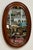 Vintage oval farmhouse style wood framed wall mirror. Features nice, rich natural wood tones with beveled frame. Age wear....