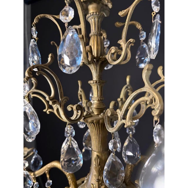 Vintage French Ornate Brass & Crystal Six-Light Chandelier Bring timeless French elegance to your home with this...