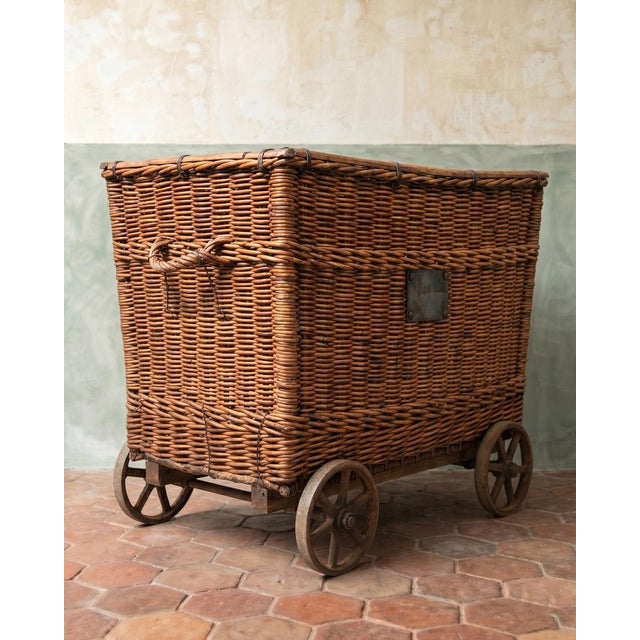 An early 20th century basket trolley from the french sncf railway network, woven in sturdy willow and still standing...