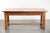 This antique French dining table features a fruitwood top and an oak base and dates from the 18th century. This...