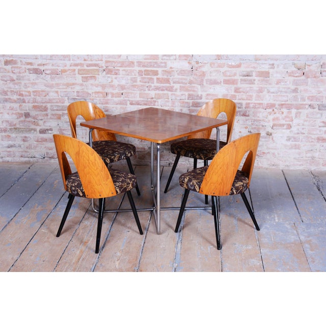 This set of four chairs from the mid-20th century, designed by architect Antonín Suman, is a fine example of Czechoslovak...