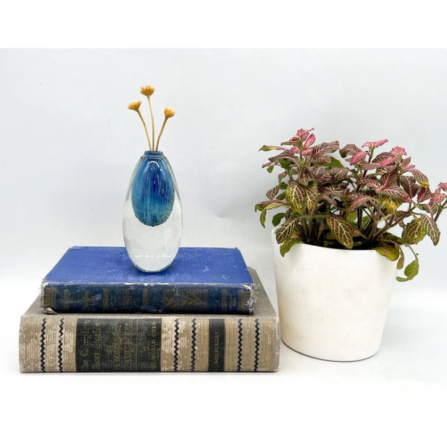 Exquisite piece of hand blown art glass bud vase by master glassblower Robert Burch. Features a blue/ green oval inside...