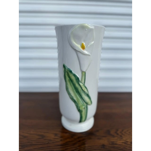 This Italian Majolica floral vase features a sculptural raised relief of elegant calla lilies and lush green leaves,...