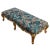 A Louis XV style oversized giltwood carved bench with six legs and upholstered in blue tapestry fabric with leaves and...