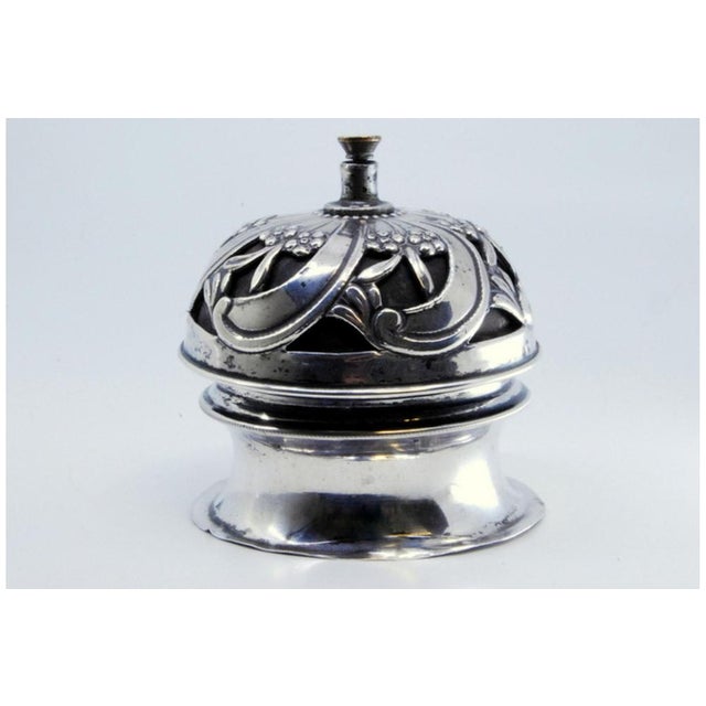 Spiral Silver Bell with Cut-Out, Floral Motifs and Interior Mechanism, in Very Good conditions. Designed 1890 to 1919 This...