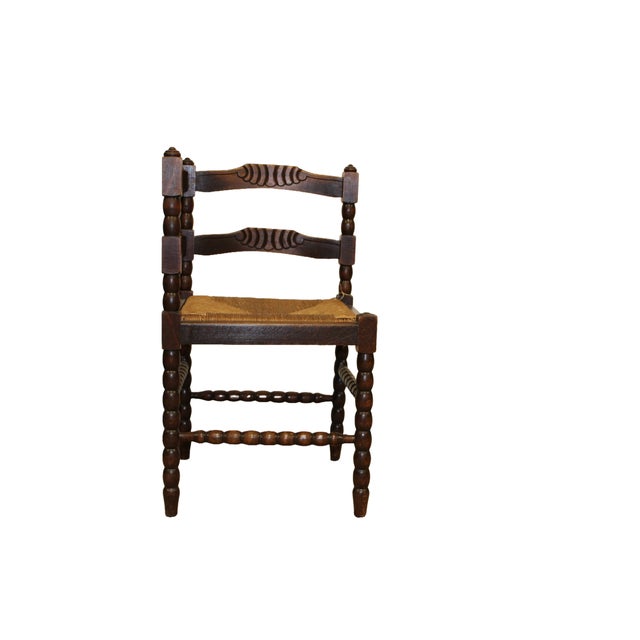 Cane Seat with Bobbin Twist Legs & Strechers. Oak corner chair featuring a cane seat and a dark stained finish. The chair...