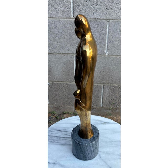 Authentic 1970s mid-century modern solid brass family sculpture by Gatco. This beautifully stylized artwork depicts a...