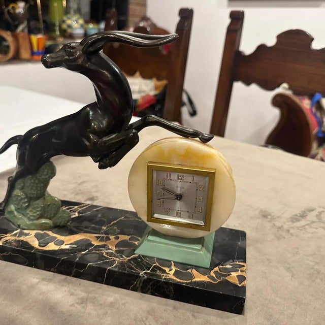 Exquisite 1930s Art Deco "Gazelle" Mantel Clock in Portoro Marble and Patinated Metal. This magnificent and rare Art Deco...
