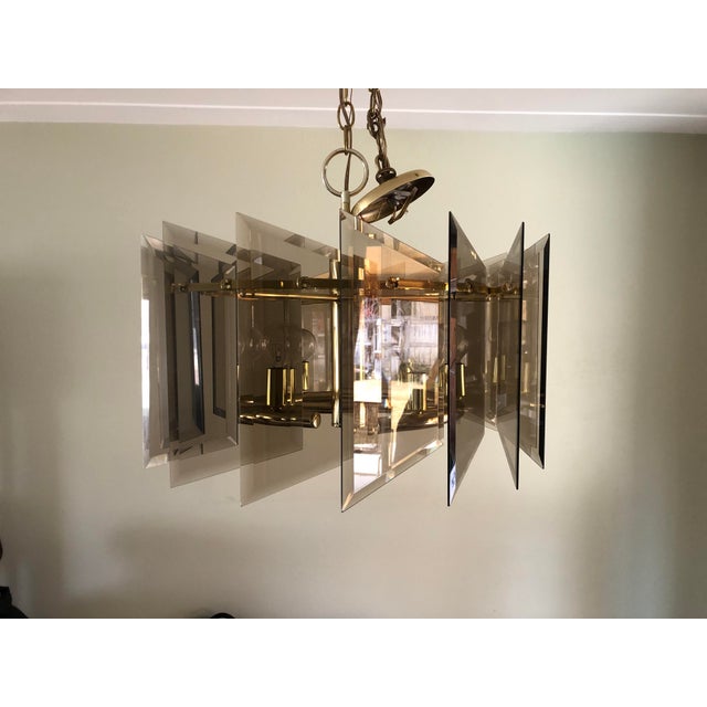 Italian crafted geometric small chandelier with layered smoked glass and polished brass hardware; circa 1970s.