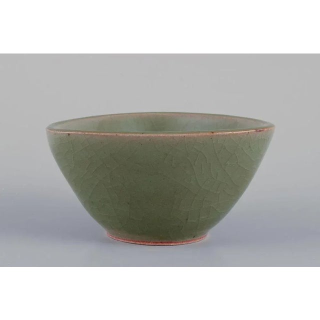 Jais Nielsen for Royal Copenhagen. Ceramic bowl in green glaze. Crackled. Motif of a mythical creature. Model 2760. Dated:...