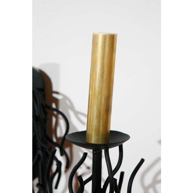 Faux black coral sconce with two arms. Newly made brass candle covers. Matches a listed black coral chandelier.