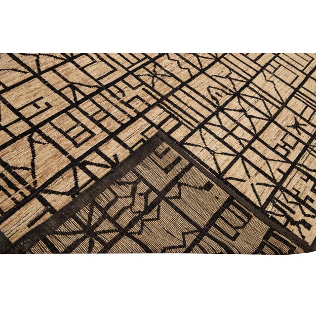 Beautiful Moroccan style handmade wool rug with a beige field. This Modern rug has brown accents featuring a gorgeous all-...