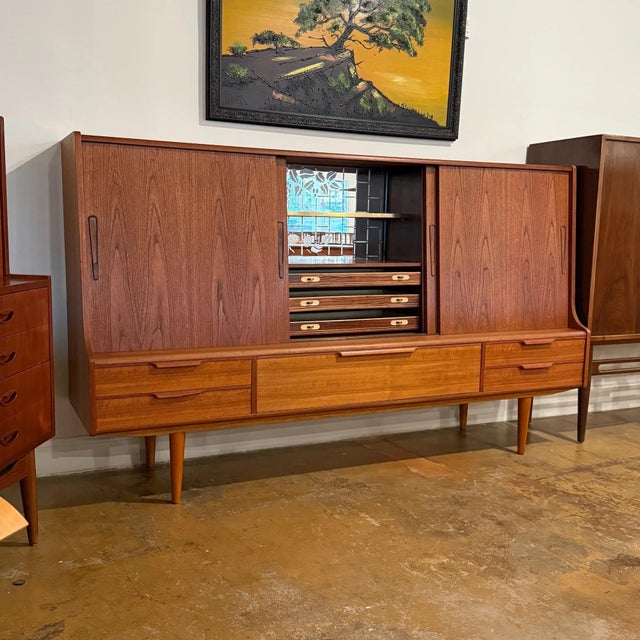 Vintage mid-century Danish modern Model 87 teak cocktail highboard manufactured by ES Møbelfabrik of Denmark. Features...