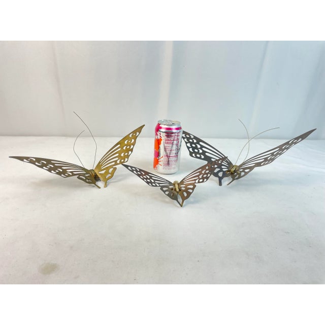 Set of 3 Brass Butterfly Wall Hangings. They each vary in size from 8.5 inches, 11.25 inches and 12.75 inches wide...