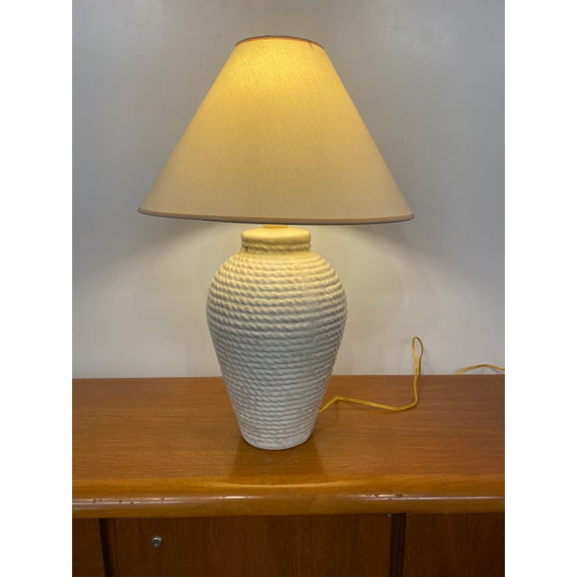 1980s white faux rope ceramic table lamp with shade. Dimensions without the shade are 21” tall to the top of socket x...