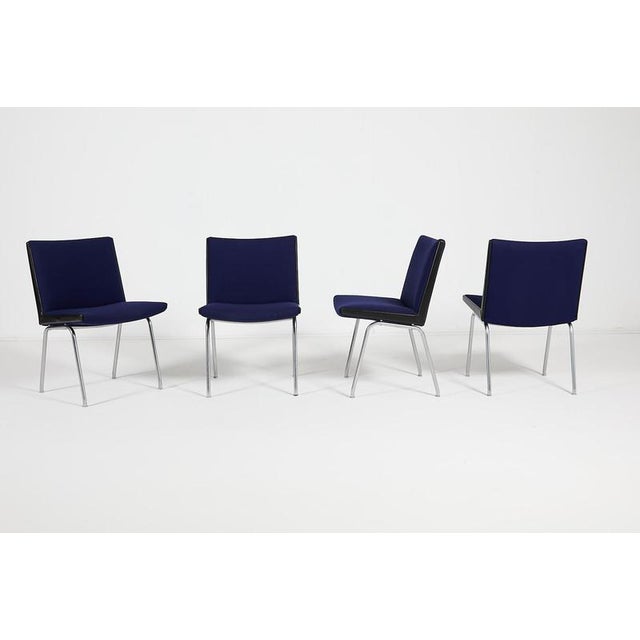 Set of 4 Danish Modern chair model ‘AP 40’ from Hans J. Wegener. Features steel frame with new dark blue fabric upholstery...
