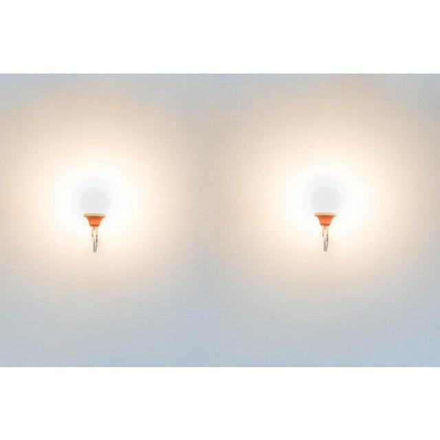 Vintage Italian design pair of wall lamps with steel frame and white opal glass shades. Condition Good. I have official...