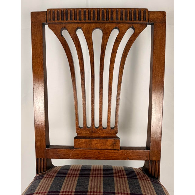A handsome 19th-century French Directoire style walnut side chair, featuring a tall rectangular back with an elegant...