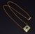 This necklace features a luxurious domed halo design centered around a vibrant natural octagonal step cut emerald weighing...
