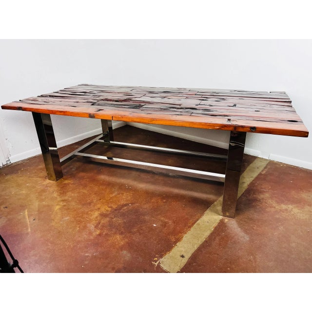 Nature transforms into a functional work of art with a handcrafted table that showcases the beauty of wood. Stainless...