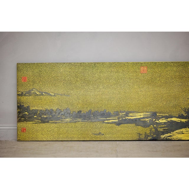 "About the Item This elongated Chinese landscape panel presents a shimmering, gilt-toned vista rendered in a deep black...