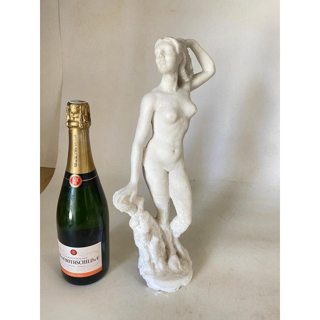 This sculpture is a Body of a woman, with one hand in the hairs. This is in marble powder, in a White color, and has been...