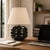 Crafted with high visual clarity, this modern table lamp features a sleek silhouette with a hand-blown glass base paired...