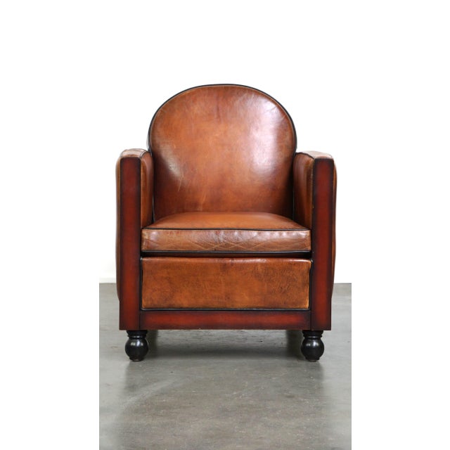 We are offering this sheepskin Art Deco design armchair finished with wood and beautiful cognac-colored leather. This...