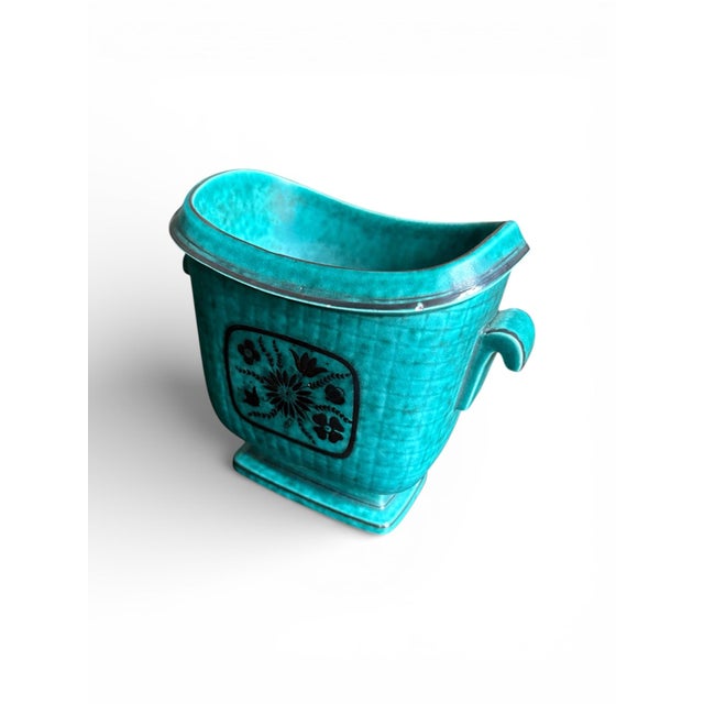 This stunning ceramic turquoise vase has applied designs of flowers and leafs and was designed by Wilhelm Kåge for...