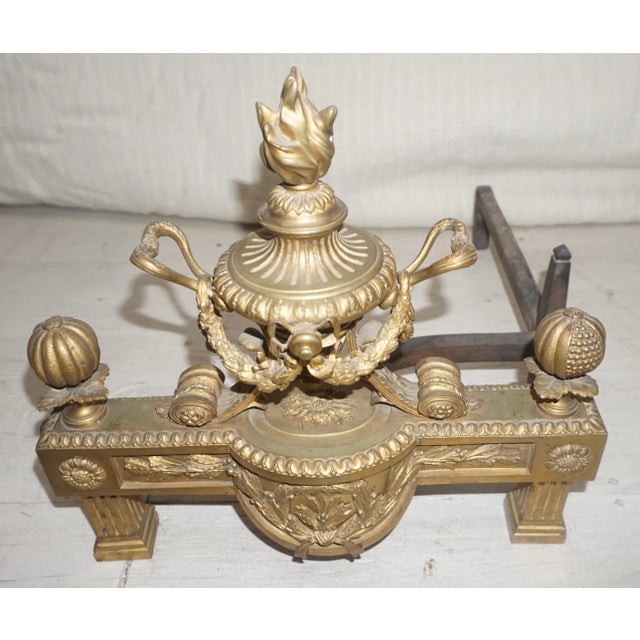 A equal pair of 19th Century French ornate gilded Bronze Chenets ,These are a Neoclassical design, with a large urn draped...