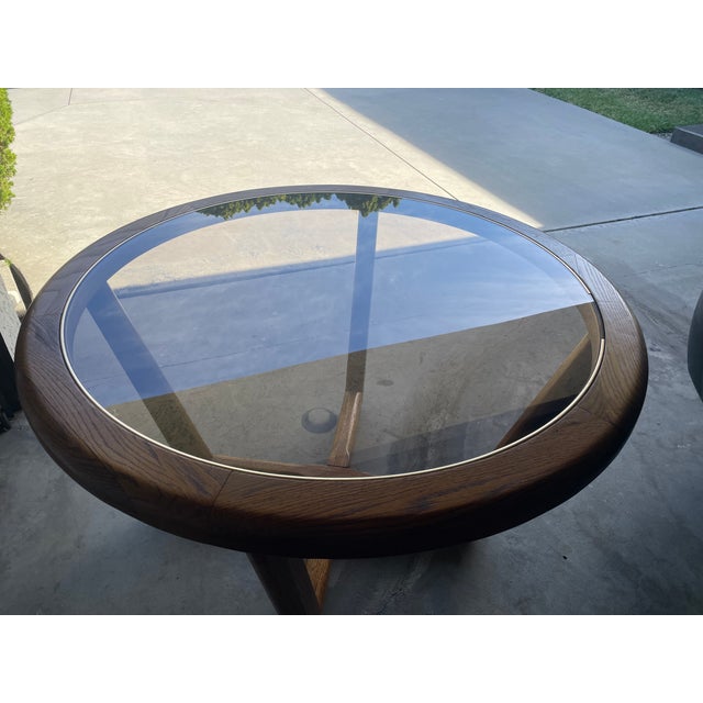 Selling a beautiful vintage round dining table featuring a glass top and a unique, stylish interlocking geometric wood...