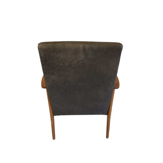 Wonderful mid-century arm chair with distressed leather upholstery. Beautiful carved walnut arms and legs, very sturdy.