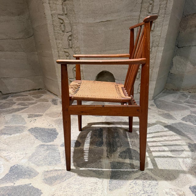 For your consideration, a solid wood frame with a curved spindle backrest and a woven paper cord seat. Made in Denmark...
