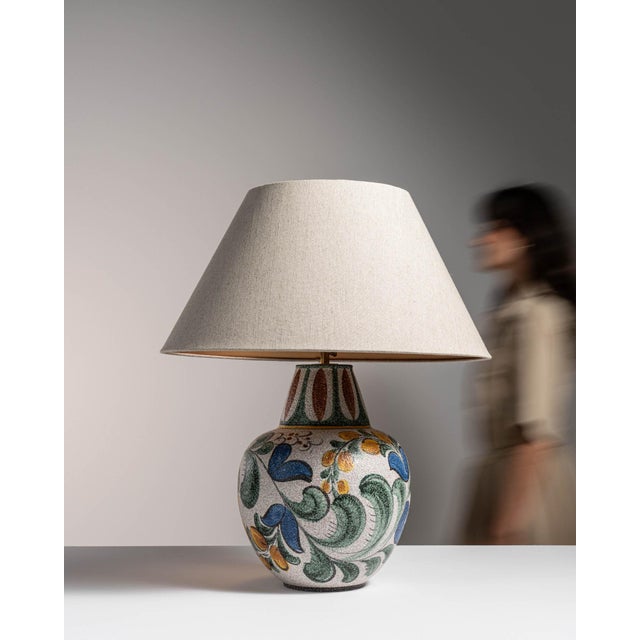 This 1970s table lamp from Germany is finished in blue, worked in ceramic. Its form follows honest, well-proportioned...