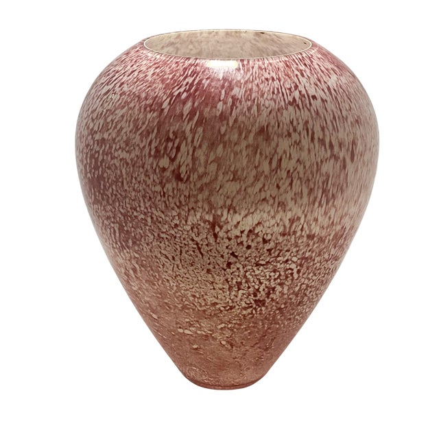 A striking large vintage art glass vase featuring a rich red body with white spatter throughout. The form is rounded and...