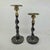 Vintage brass and bronze candlestick holders feature a striking barley twist stem design with ornate scalloped drip pans....