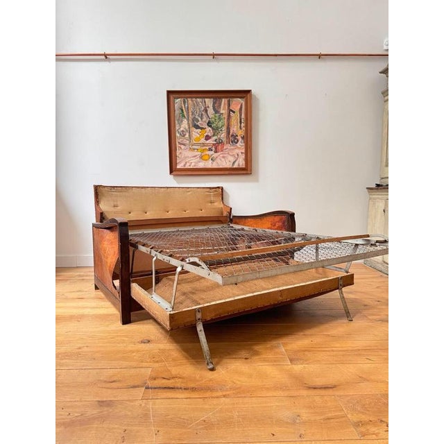 An ever cool French leather 1930’s mustached back sofa bed. Easily pulled out to a double bed and lovely looking as a...