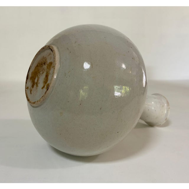 A KOREAN STONEWARE WINE VESSEL, CHOSON DYNASTY This was likely created circa 1850 or possibly earlier. The compressed...