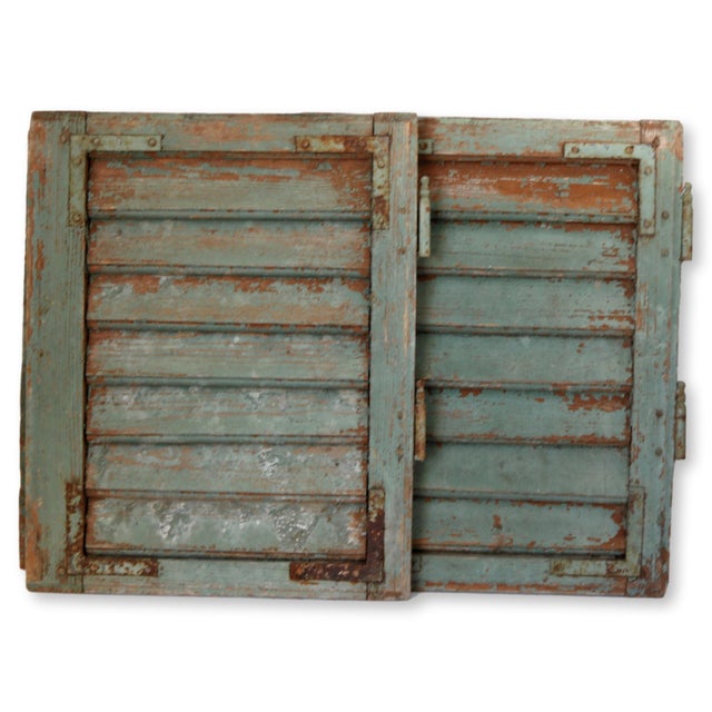 Pair of antique French shutters with some original hardware. Paint is very "chippy", please handle with care as if flakes...