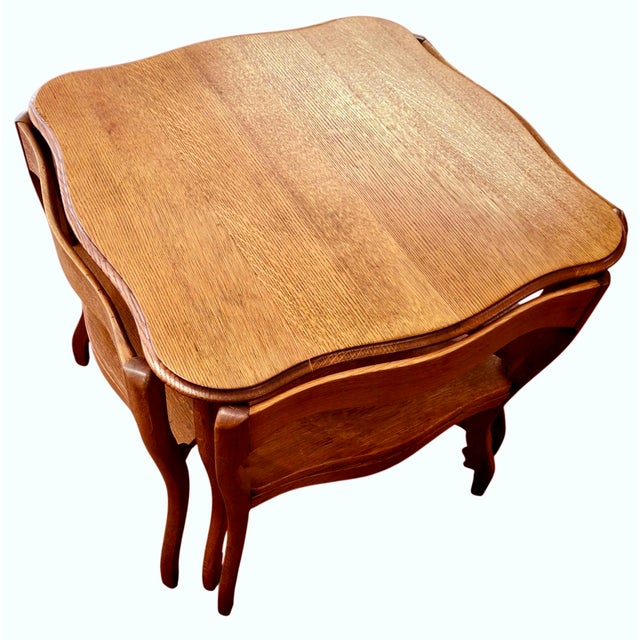 On offer is a charming French Provencial-style, scalloped-edge square table with four triangular nesting chairs. Measuring...