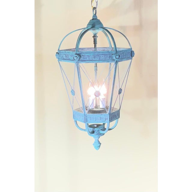 Elevate your space with this stunning, restored solid brass hanging lantern chandelier. Featuring a striking, verdigris...