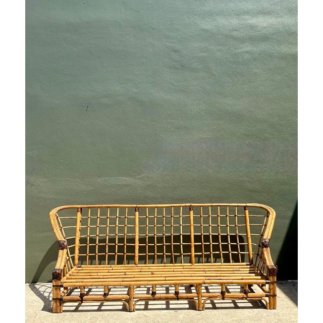 Exuding grand mid-century resort elegance and organic architectural presence, this vintage high-back sofa showcases...